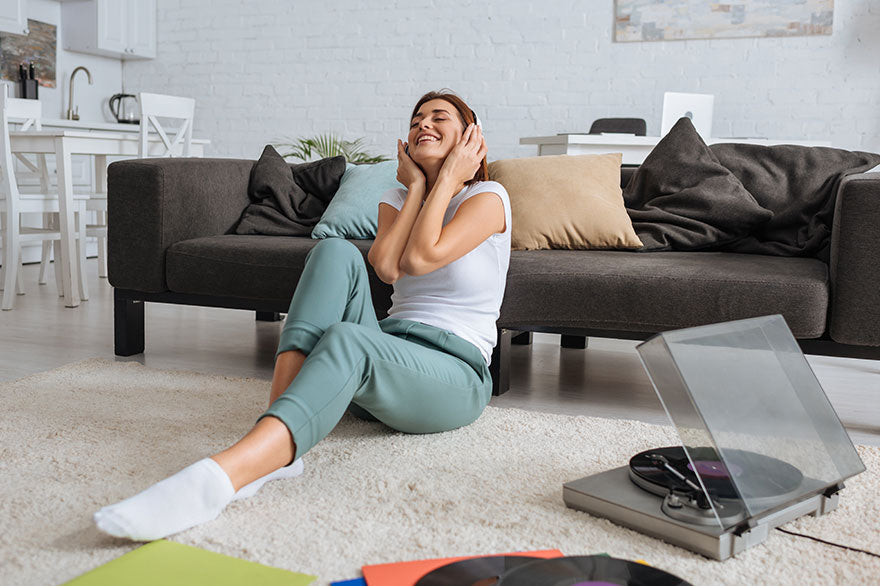 Cheerful girl listening music in headphones